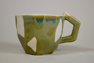 green mug with wax resisted spots.